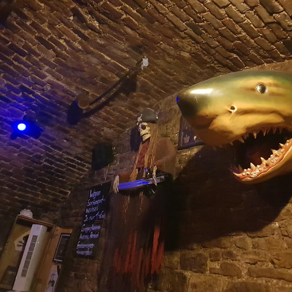 A pirate skeleton with a sword, a shark, and brick walls.